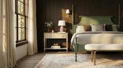 A furnished bedroom with layered neutral fabrics and warm lighting