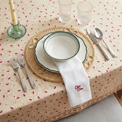 Ceramic tableware styled with woven textures and a patterned tablecloth