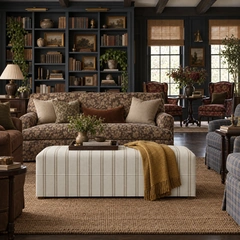 A furnished reading room with bookshelves and soft seating